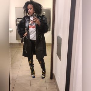 A faux fur and faux leather knee length jacket